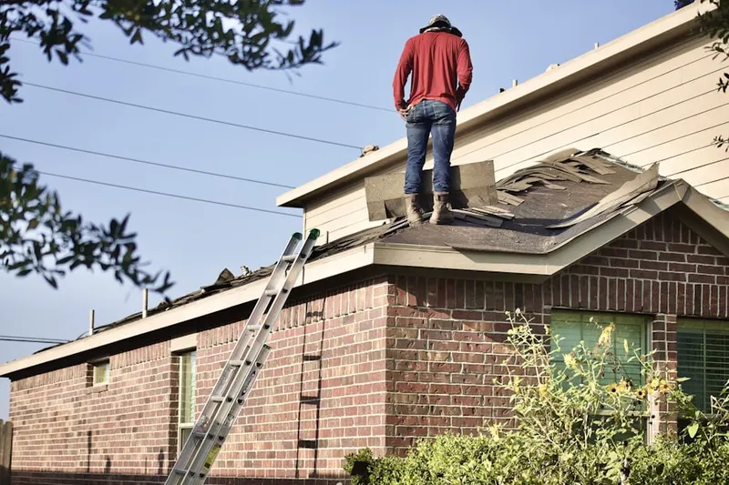 Professional roofer working on a residential roof in Mead Valley